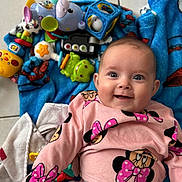 Leewane participe au concours pour gagner de l'argent avec cette photo : baby, smiling, pink_clothing, minnie_mouse, blanket, toys, blue_blanket, indoor, floor_tiles, happy, child, cute, infant, playtime, colorful, face, person, portrait, clothing, lying_down