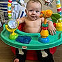Wyatt joined the competition — help win amazing prizes! baby, child, smiling, activity_center, toy, colorful, playful, indoor, floor, pillow, robot, plastic, giraffe_toy, blue_toy, green_toy, black_pants, bone_design, happy, cute, infant