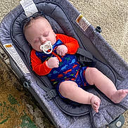 Wyatt joined the competition — help win amazing prizes! baby, infant, sleeping, pacifier, baby_rocker, dinosaur_print, colorful_clothing, outdoor, gray, seat, child, cute, resting, comfort, legs, arms, head, skin, fabric, strap