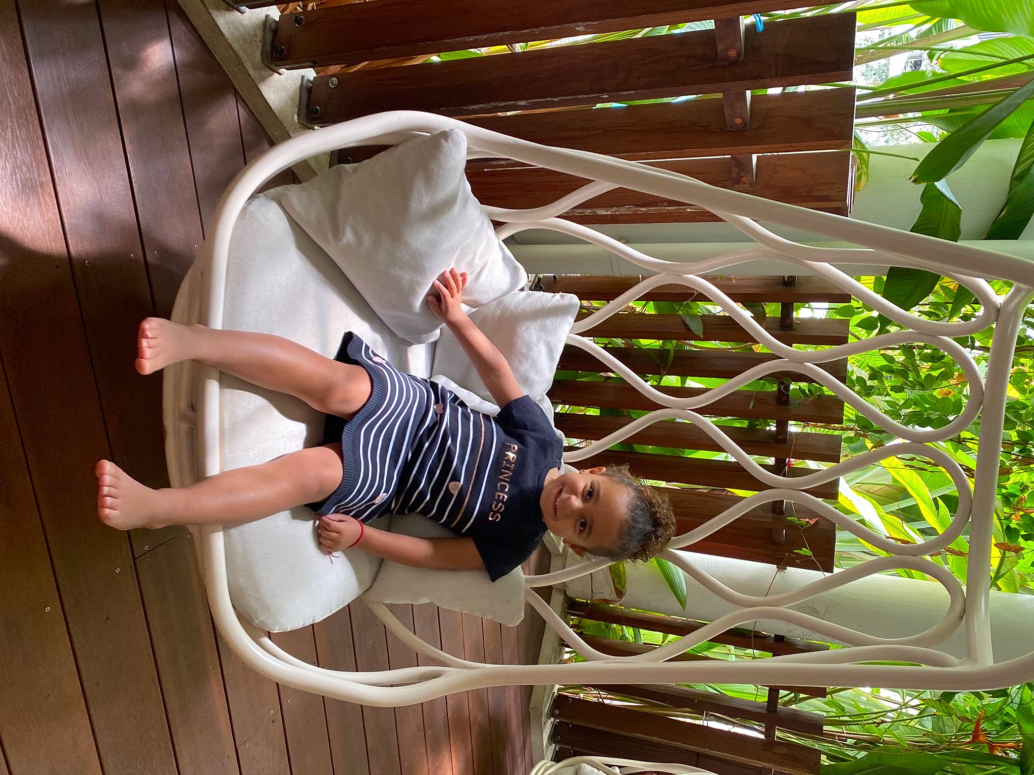 Enola participe au concours pour gagner de l'argent avec cette photo : child, daylighting, fun, handrail, hat, human_leg, joy, knee, leisure, pattern, person, plant, sandal, shorts, sneakers, t_shirt, terrestrial_plant, thigh, white, wood