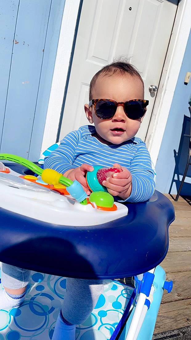 Zakai is registered to the contest to win money with this photo: baby, baby_playing_with_toys, baby_products, baby_toddler_clothing, blue, chair, child, door, electric_blue, eyewear, fun, goggles, hairstyle, happy, leisure, person, plastic, product, sitting, sunglasses