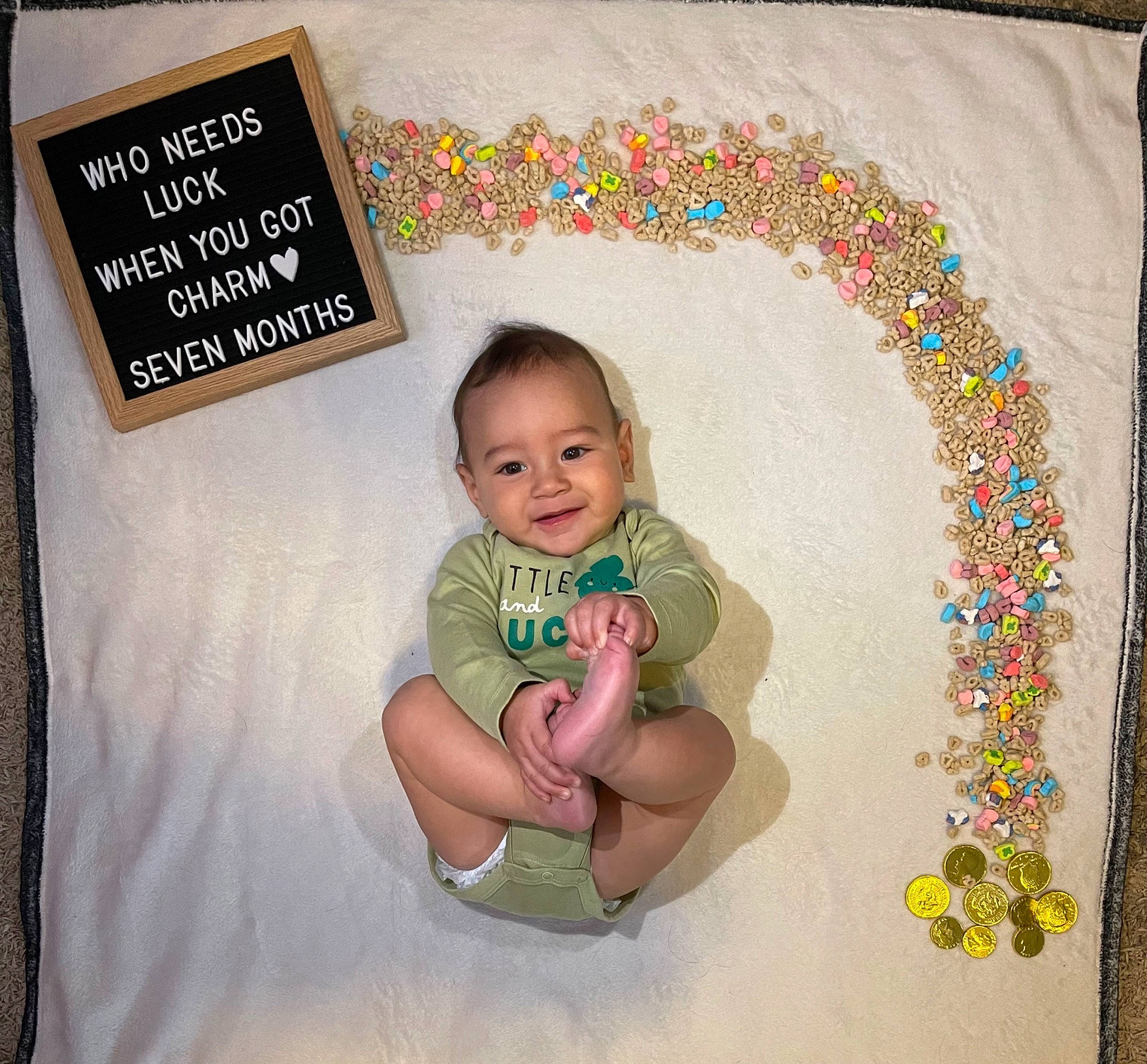 Zakai is registered to the contest to win money with this photo: art, baby, baby_toddler_clothing, cheek, child, circle, facial_expression, font, happy, illustration, joy, linens, pattern, person, product, rectangle, room, sleeve, smile, t_shirt