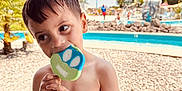 Ashtyn joined the competition — help win amazing prizes! bench, blue_sky, boy, child, food, happy, outdoor, palm_tree, playful, pool, popsicle, portrait, recreation, rocks, smile, summer, sunny, swimwear, vacation, water