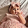 baby, child, infant, pink, headband, bow, dress, tulle, hearts, bed, blanket, hand, face, eyes, cute, portrait, indoors, soft_lighting, lying_down, person