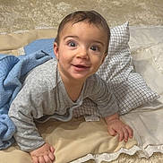 Saif participe au concours pour gagner de l'argent avec cette photo : baby, blanket, carpet, child, clothing, cozy, cute, expression, face, floor, hands, happy, home, indoors, infant, person, pillow, portrait, smiling, young