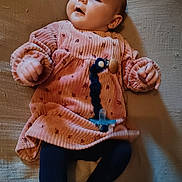 Cléo joined the competition — help win amazing prizes! baby, infant, pink_dress, pacifier, lying_down, blanket, navy_tights, cute, child, young, indoors, portrait, soft_lighting, clothing, hands, feet, face, expression, baby_accessory, relaxed
