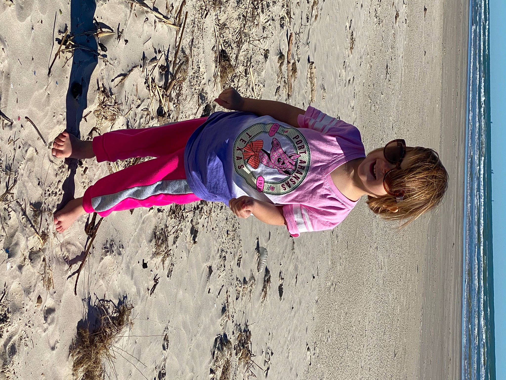 River joined the competition — help win amazing prizes! baby_toddler_clothing, beach, coast, fun, holiday, joy, leisure, magenta, ocean, outdoor_shoe, people_in_nature, people_on_beach, person, pink, play, purple, sand, sea, shore, summer