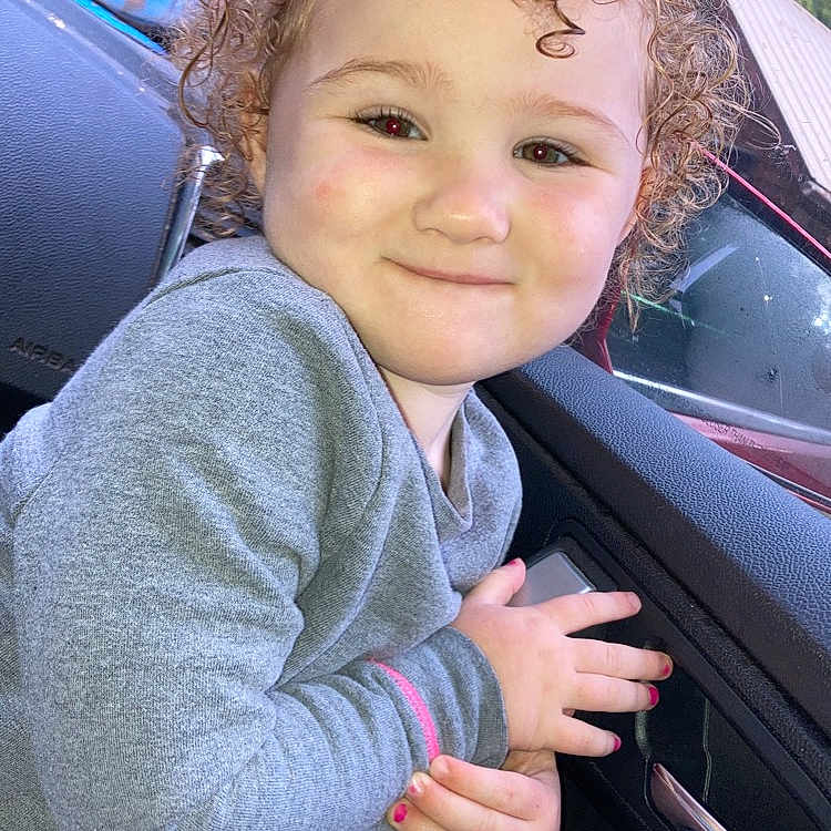 Layla is registered to the contest to win money with this photo: alloywheel, baby, blonde, bodypart, car, carwheel, clothing, coat, face, finger, hair, hand, happy, head, jacket, machine, person, photography, portrait, smile