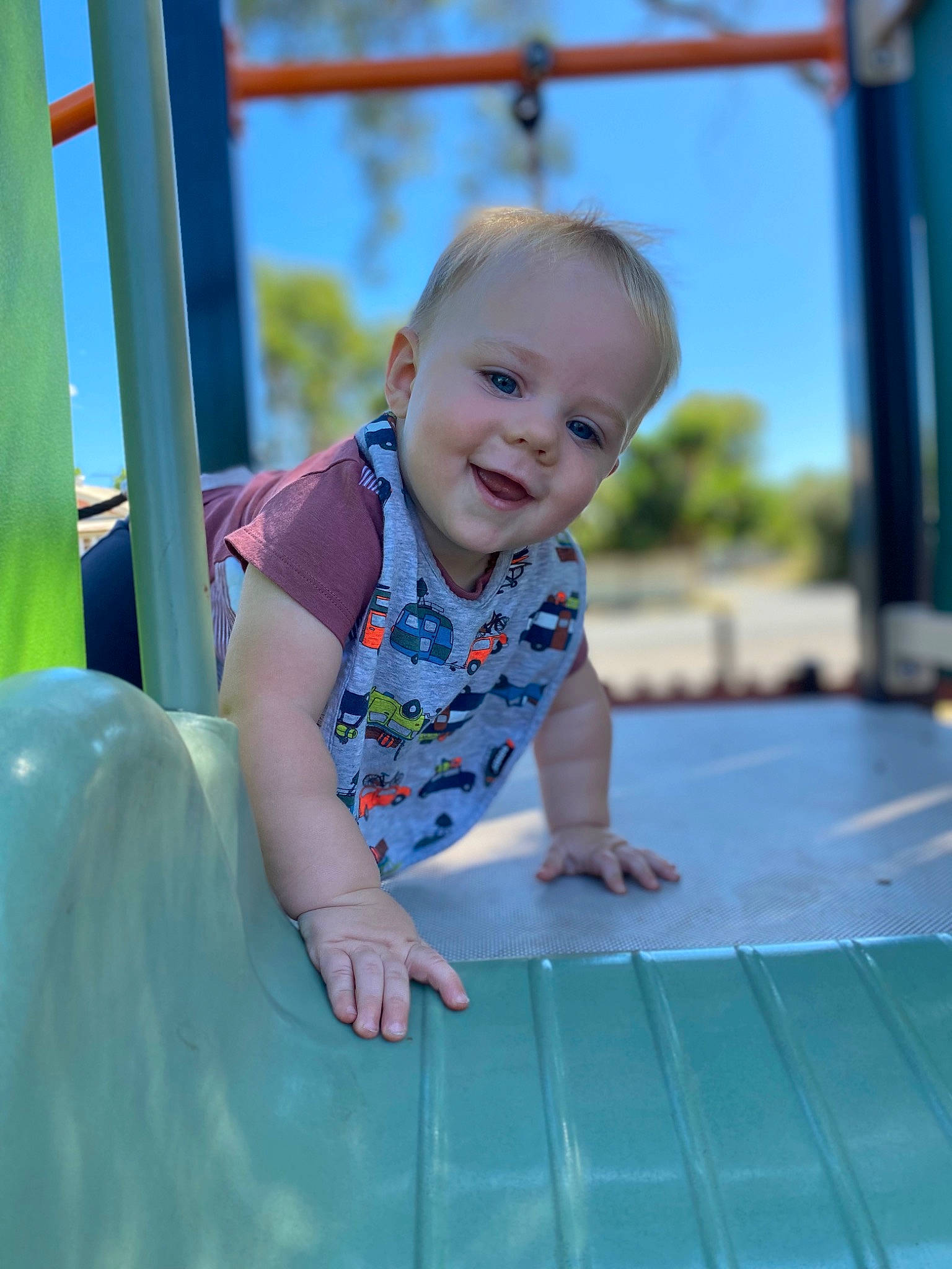 Jai is registered to the contest to win money with this photo: baby, baby_toddler_clothing, blue, child, city, electric_blue, flooring, fun, grass, happy, leisure, outdoor_play_equipment, person, playground, recreation, skin, sky, smile, standing, toddler