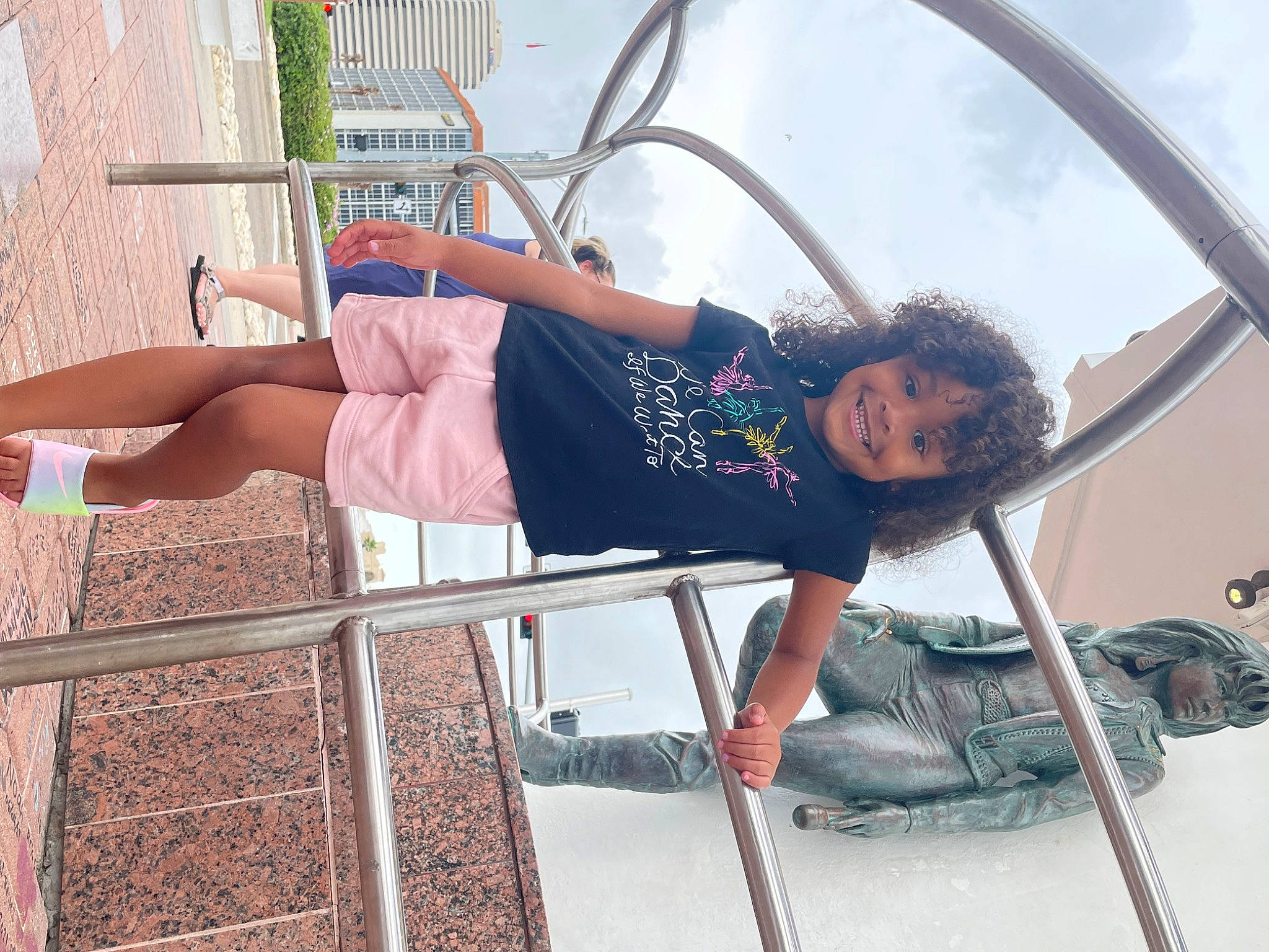 Dezirae is registered to the contest to win money with this photo: boot, chair, fun, human_leg, joy, knee, leg, leisure, outdoor_play_equipment, person, plant, recreation, sandal, shorts, sitting, sky, smile, sneakers, t_shirt, thigh