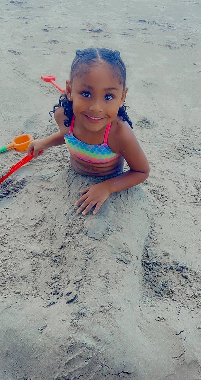 Dezirae is registered to the contest to win money with this photo: baby, barefoot, beach, child, eye, fun, hand, happy, joy, leisure, ocean, people_in_nature, people_on_beach, person, play, recreation, sand, smile, soil, toddler