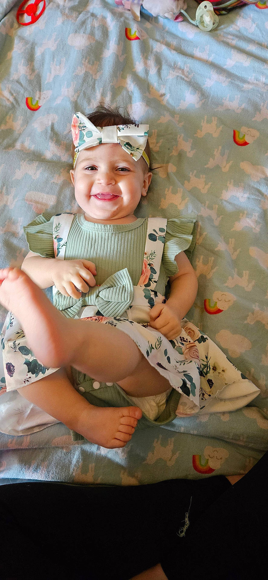 Makenna is registered to the contest to win money with this photo: accessories, baby, bed, bodypart, clothing, couch, cushion, dress, face, furniture, happy, hat, head, homedecor, laughing, person, photography, portrait, quilt, smile