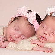 Ayda And Pera Twins is registered to the contest to win money with this photo: newborn, baby, sleeping, headband, pink, bow, twin, infant, soft, knitted, sweater, cute, peaceful, portrait, resting, face, hands, skin, closeup, studio