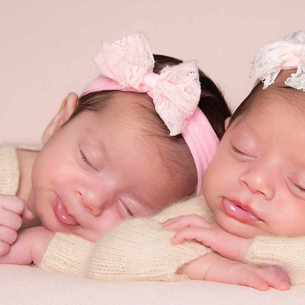 Ayda And Pera Twins is registered to the contest to win money with this photo: baby, bow, closeup, cute, face, hands, headband, infant, knitted, newborn, peaceful, pink, portrait, resting, skin, sleeping, soft, studio, sweater, twin