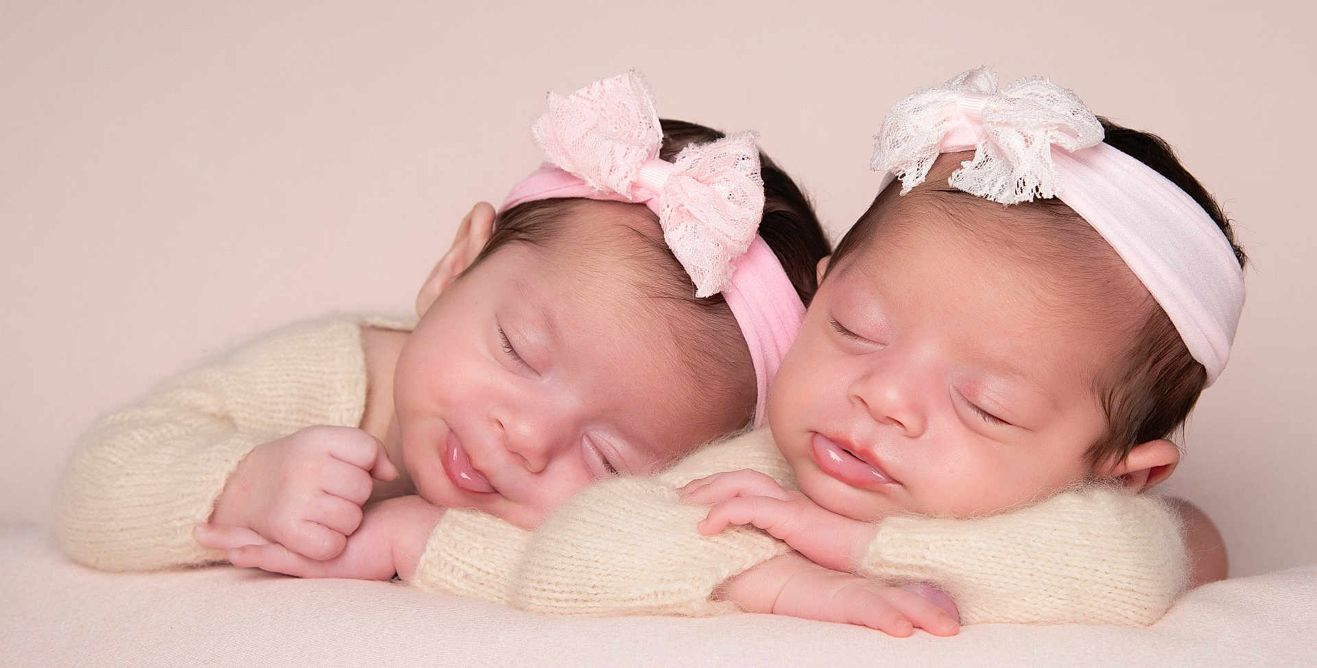 Ayda And Pera Twins is registered to the contest to win money with this photo: newborn, baby, sleeping, headband, pink, bow, twin, infant, soft, knitted, sweater, cute, peaceful, portrait, resting, face, hands, skin, closeup, studio