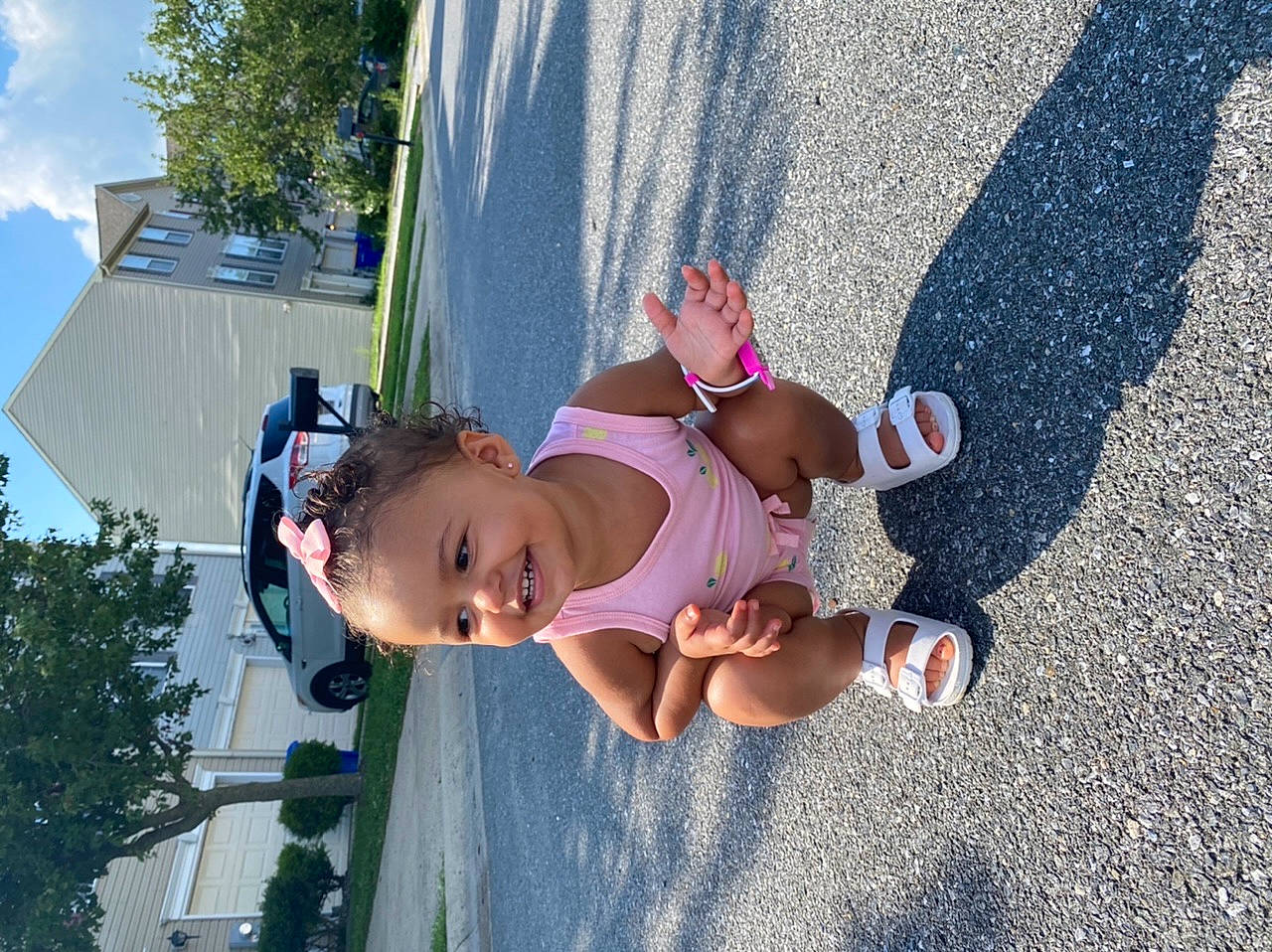 Amiya is registered to the contest to win money with this photo: asphalt, baby, child, city, cloud, eyewear, fun, grass, hat, house, human_leg, joy, leisure, person, plant, recreation, shorts, sky, summer, toddler