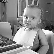 Côme a rejoint le concours — aidez-le/la à gagner de superbes lots ! toddler, child, bib, table, pastry, living_room, sofa, couch, pajamas, window, chair, curious, indoor, person, furniture, black_and_white, young_child, face, hair, expression