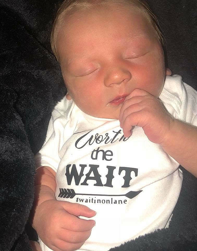 Lane is registered to the contest to win money with this photo: cheek, child, chin, cool, day, ear, facial_expression, finger, forehead, hand, head, infant, lip, mouth, nose, person, product, smile, t_shirt, toddler