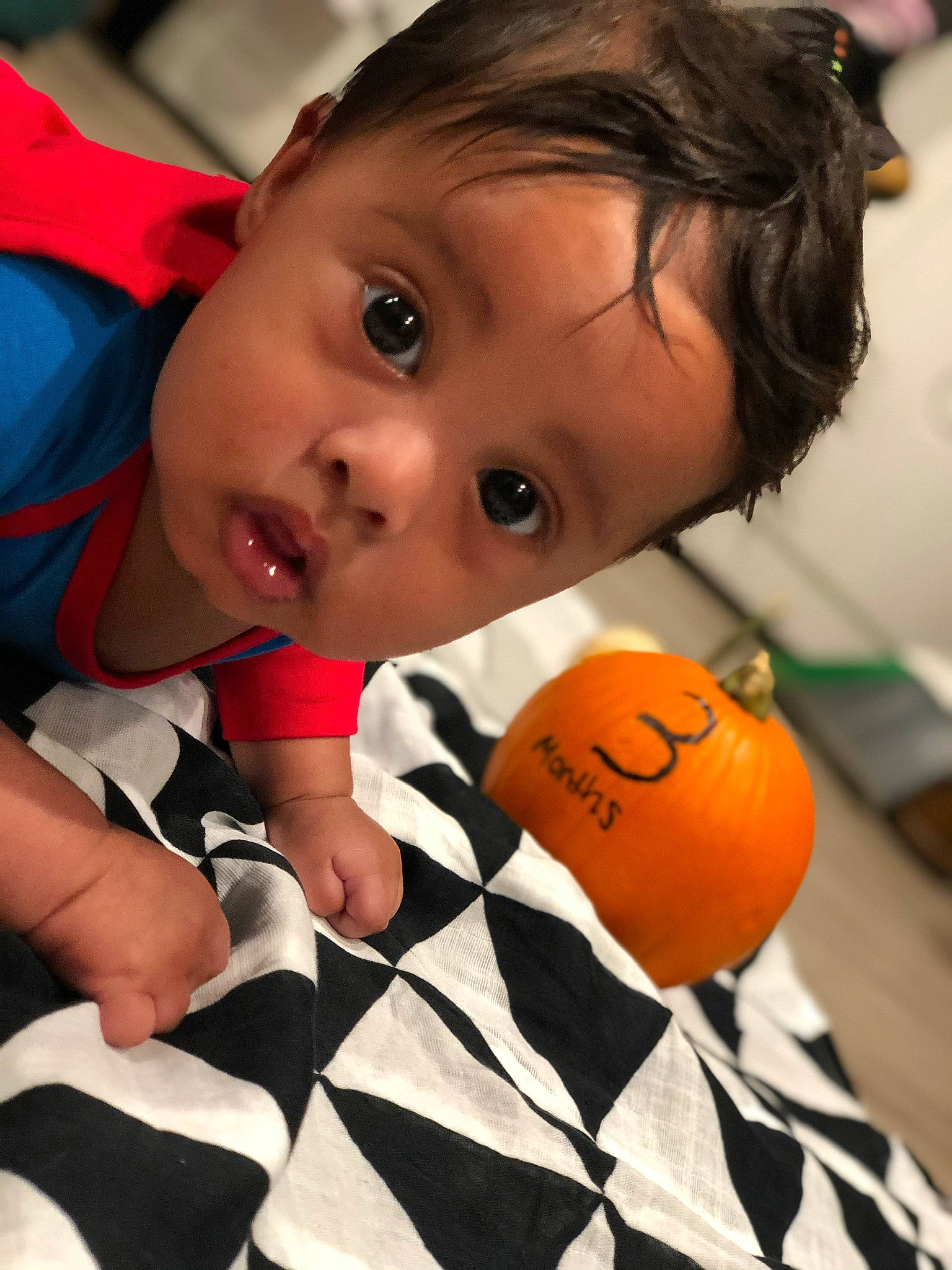 Jr is registered to the contest to win money with this photo: baby, ball, child, cucurbita, eye, finger, flooring, fun, happy, leisure, mouth, nail, orange, people, person, play, sitting, stuffed_toy, surprise, toddler