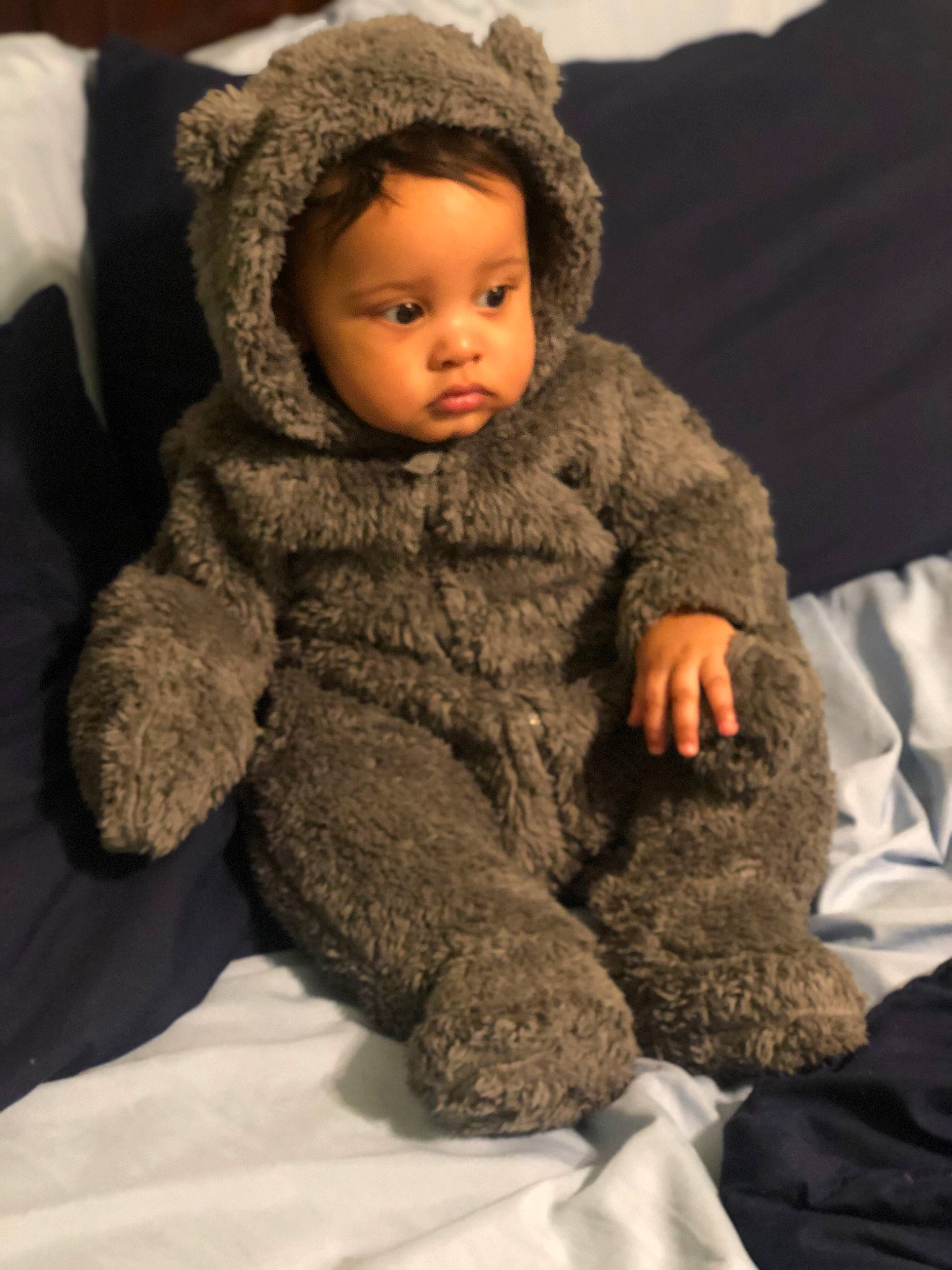 Jr is registered to the contest to win money with this photo: baby, baby_toddler_clothing, cheek, child, collar, comfort, eye, face, fur, fur_clothing, gesture, head, knit_cap, linens, military_camouflage, person, skin, sleeve, toddler, wool