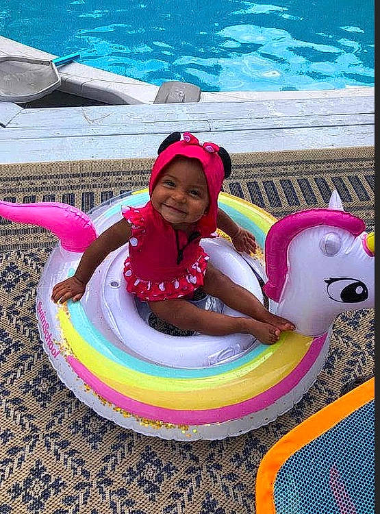 Jayde is registered to the contest to win money with this photo: baby_float, child, fun, games, headwear, inflatable, joy, leisure, magenta, person, pink, recreation, summer, swimming_pool, vacation