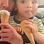 child, adult, ice_cream, cone, indoor, couch, cushion, face, hand, holding, playful, food, snack, toddler, striped_shirt, closeup, person, family, happy, home