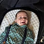baby, infant, smiling, face, green_checkered_shirt, suspenders, cushion, stroller, happy, child, young, clothing, head, person, portrait, indoor, cute, baby_boy, lying_down, comfortable