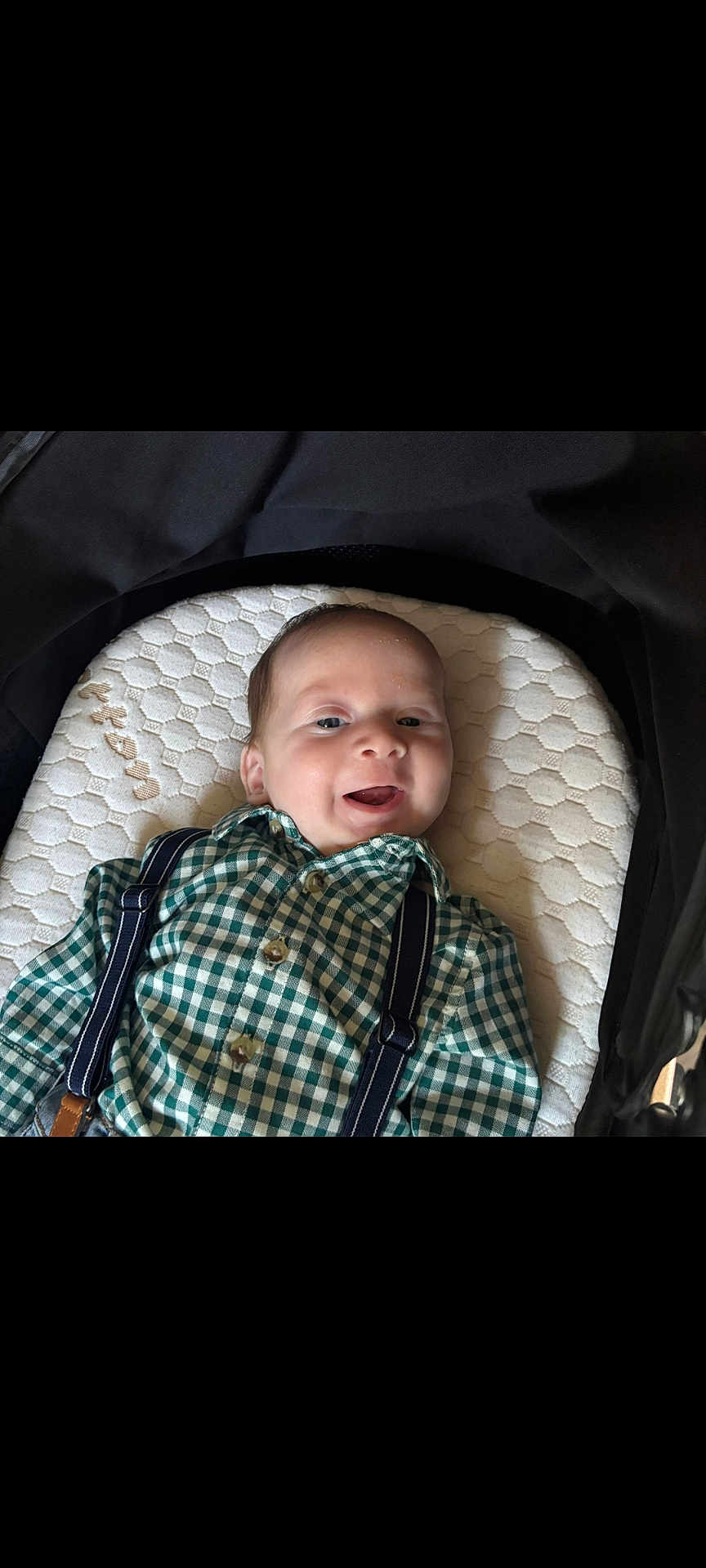 Arthur joined the competition — help win amazing prizes! baby, infant, smiling, face, green_checkered_shirt, suspenders, cushion, stroller, happy, child, young, clothing, head, person, portrait, indoor, cute, baby_boy, lying_down, comfortable