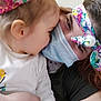 child, adult, face_mask, headband, close_up, affection, indoor, portrait, smiling_eyes, white_shirt, colorful_accessories, human, bonding, family, toddler, hair, skin, hand, cute, love