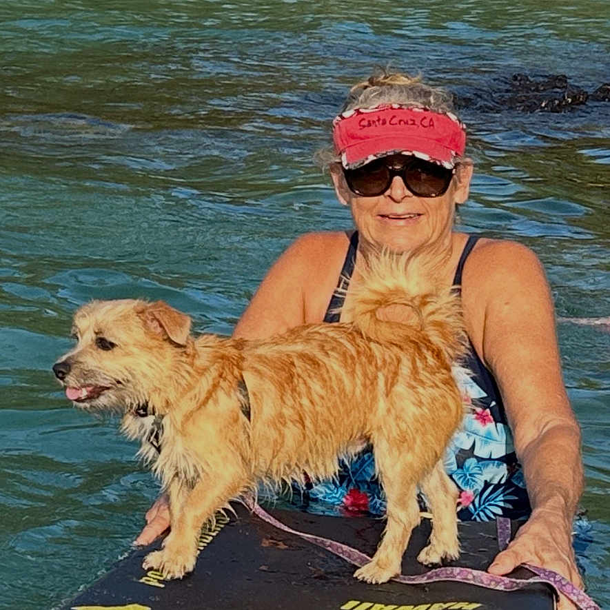Nui joined the competition — help win amazing prizes! background_people, beach, dog, leash, ocean, outdoor, paddleboard, rocks, shore, smiling, standing, summer, sunglasses, swimsuit, trees, tropical, visors, water, waves, woman