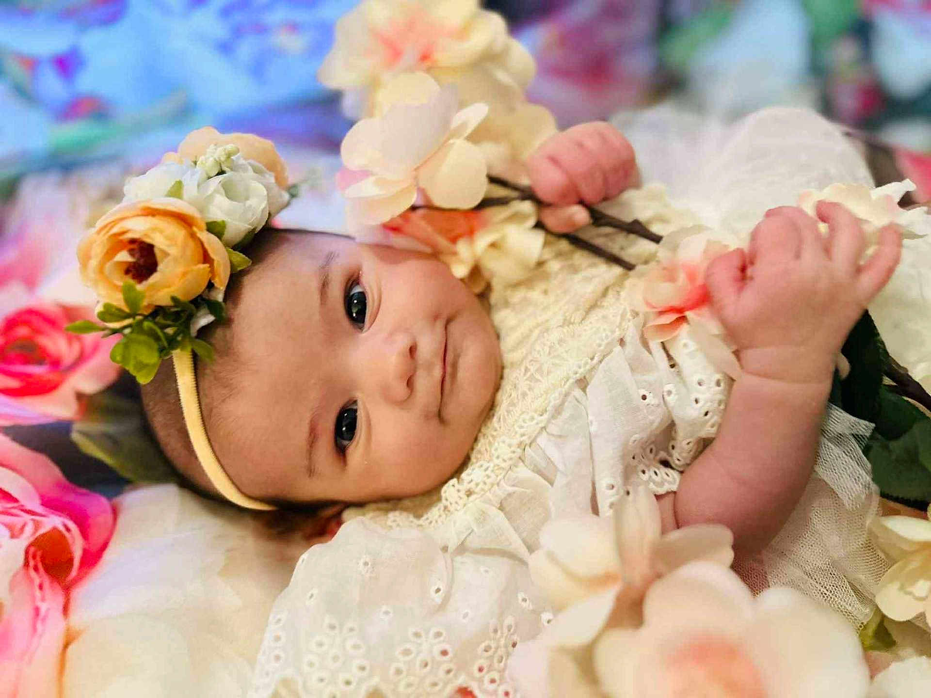 Willow joined the competition — help win amazing prizes! baby, flower, headband, white_dress, infant, cute, portrait, hands, soft, pastel_colors, floral, sleeping_area, closeup, skin, lying_down, decor, tender, young_child, innocent, peaceful