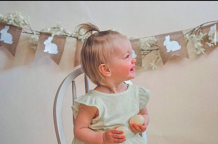 Mackenzie is registered to the contest to win money with this photo: baby, baby_toddler_clothing, child, dress, ear, embellishment, eyelash, fashion_accessory, happy, headband, headpiece, jewellery, metal, neck, pattern, peach, person, pink, room, sleeve