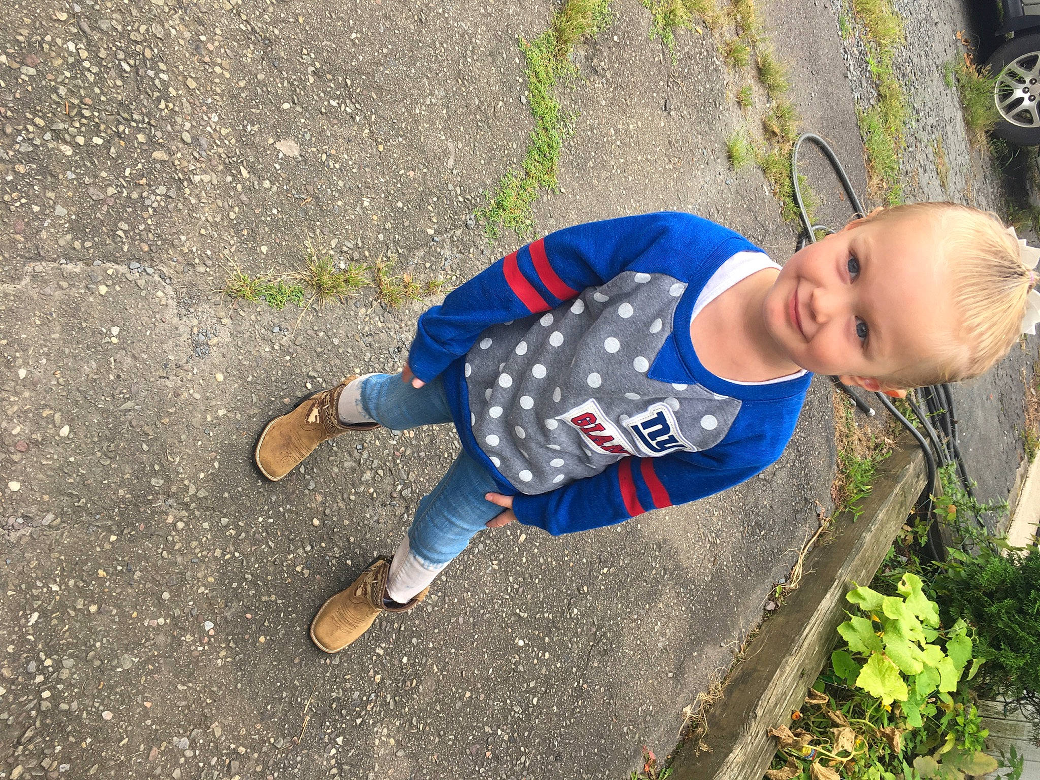 Mackenzie is registered to the contest to win money with this photo: asphalt, baby, child, denim, electric_blue, foot, fun, grass, joy, leisure, pattern, people_in_nature, person, plant, recreation, road_surface, shadow, sidewalk, soil, toddler