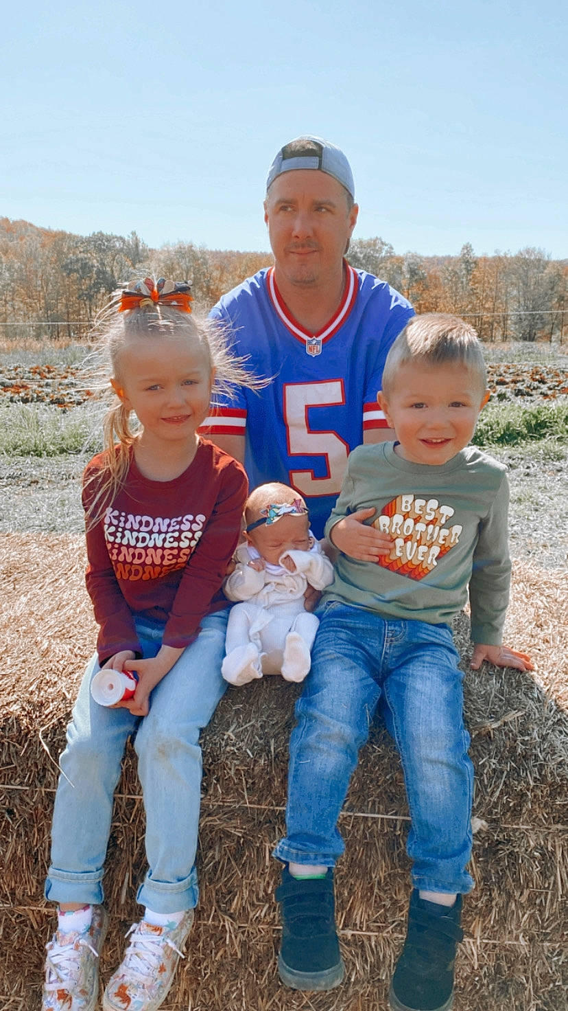 James is registered to the contest to win money with this photo: child, event, face, fun, grass, grass_family, happy, hat, head, headwear, jeans, joy, leg, people_in_nature, person, plant, prairie, shoe, sky, social_group