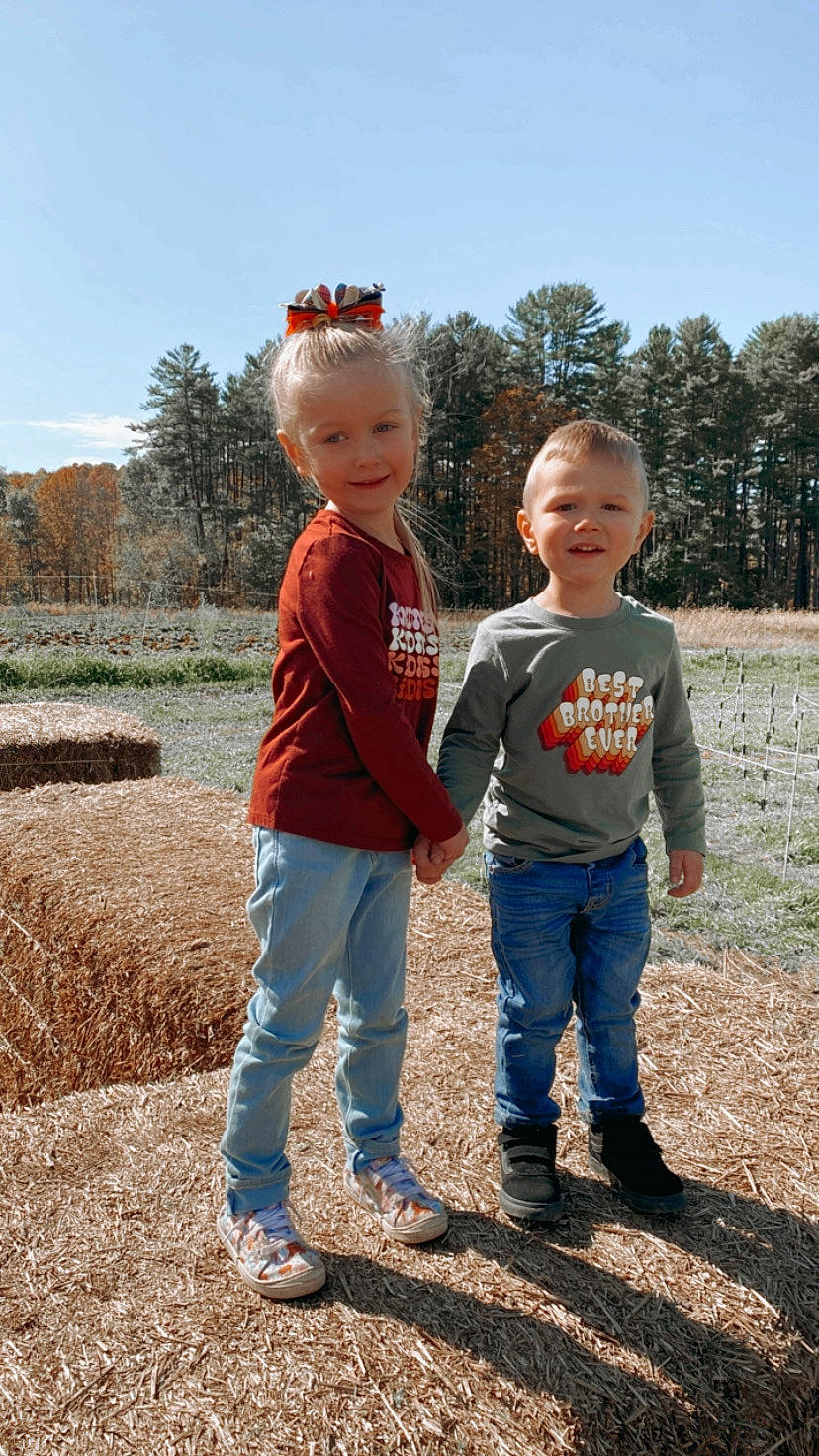James is registered to the contest to win money with this photo: child, footwear, fun, gesture, grass, grassland, happy, jeans, joy, landscape, leaf, leisure, people_in_nature, person, plant, sky, smile, sneakers, t_shirt, toddler