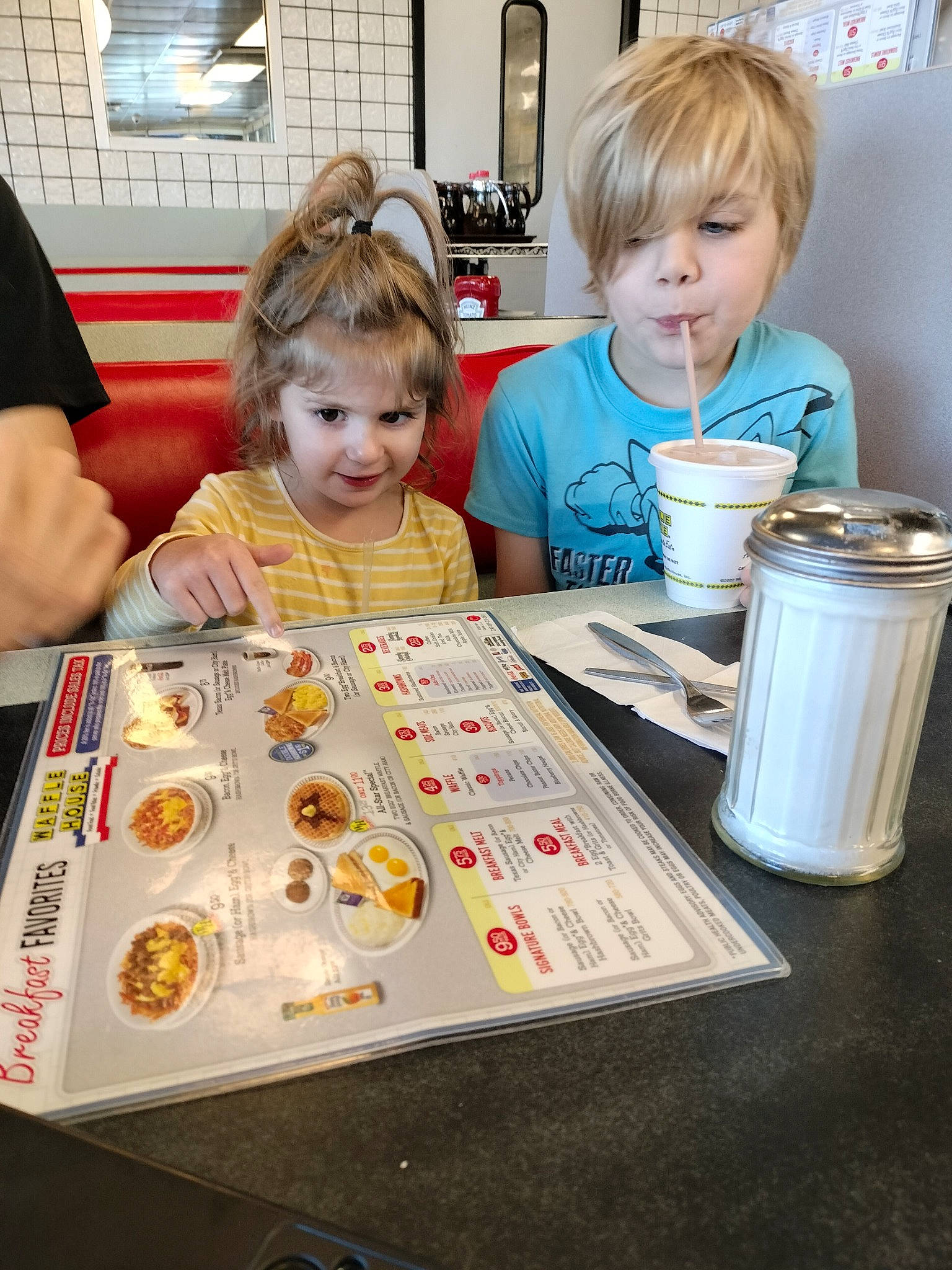 Brielle is registered to the contest to win money with this photo: baking, chair, child, comfort_food, cuisine, cup, drinkware, event, food, fun, indoor_games_and_sports, joy, meal, person, play, recreation, sharing, sweetness, t_shirt, table