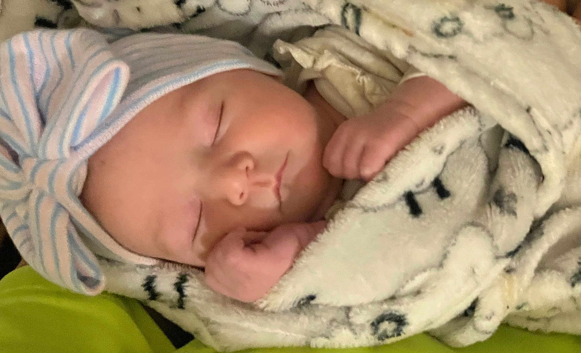 Delaney is registered to the contest to win money with this photo: baby, sleeping, blanket, hat, cozy, infant, wrapped, peaceful, cute, newborn, soft, closeup, face, resting, child, hands, warm, indoors, headwear, portrait