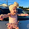accessory, arms_outstretched, baby, blue_sky, bracelet, car, child, daytime, flower, girl, happy, headband, hood, house, outdoor, pink_clothing, portrait, skirt, smile, sunlight