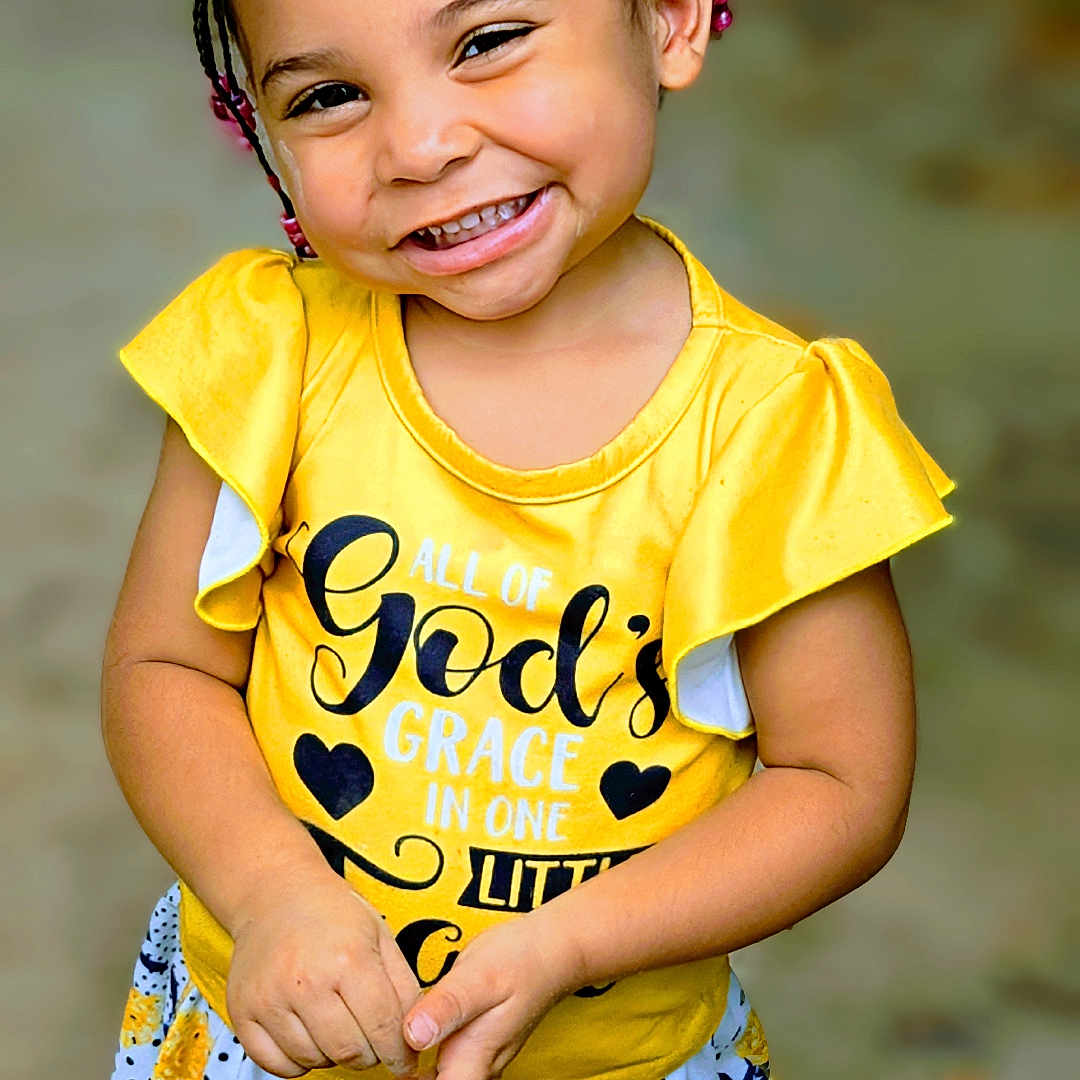 Jazi May is registered to the contest to win money with this photo: bodypart, child, clothing, dress, face, female, finger, girl, hair, hand, happy, head, laughing, person, photography, portrait, shorts, sleeve, smile, t_shirt