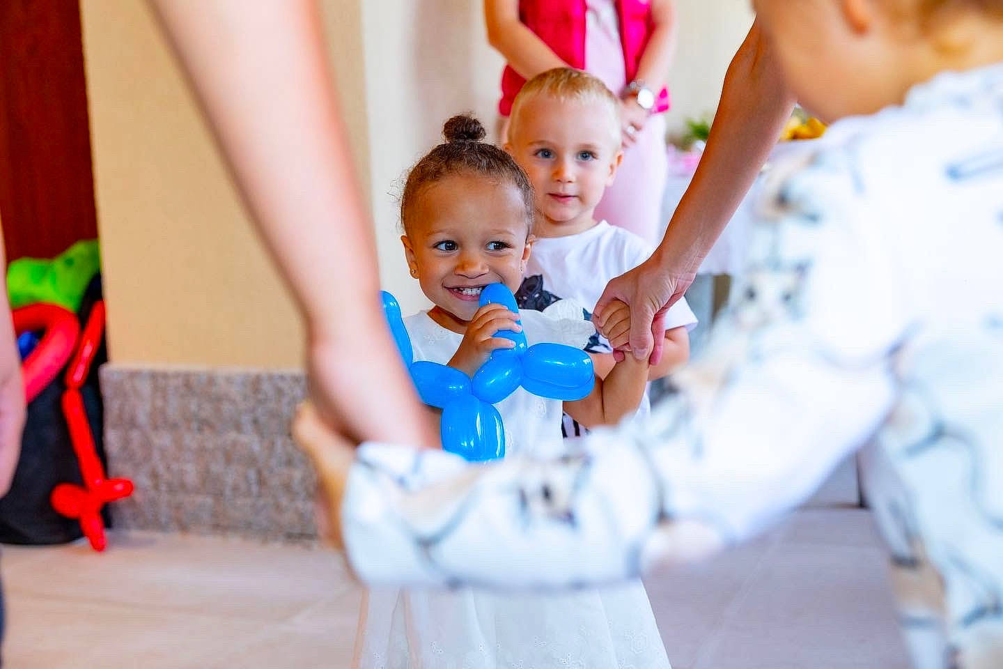 Stormi is registered to the contest to win money with this photo: baby, baby_toddler_clothing, child, contact_sport, entertainment, event, face, facial_expression, finger, fun, gesture, happy, joy, leisure, person, play, recreation, skin, sleeve, smile