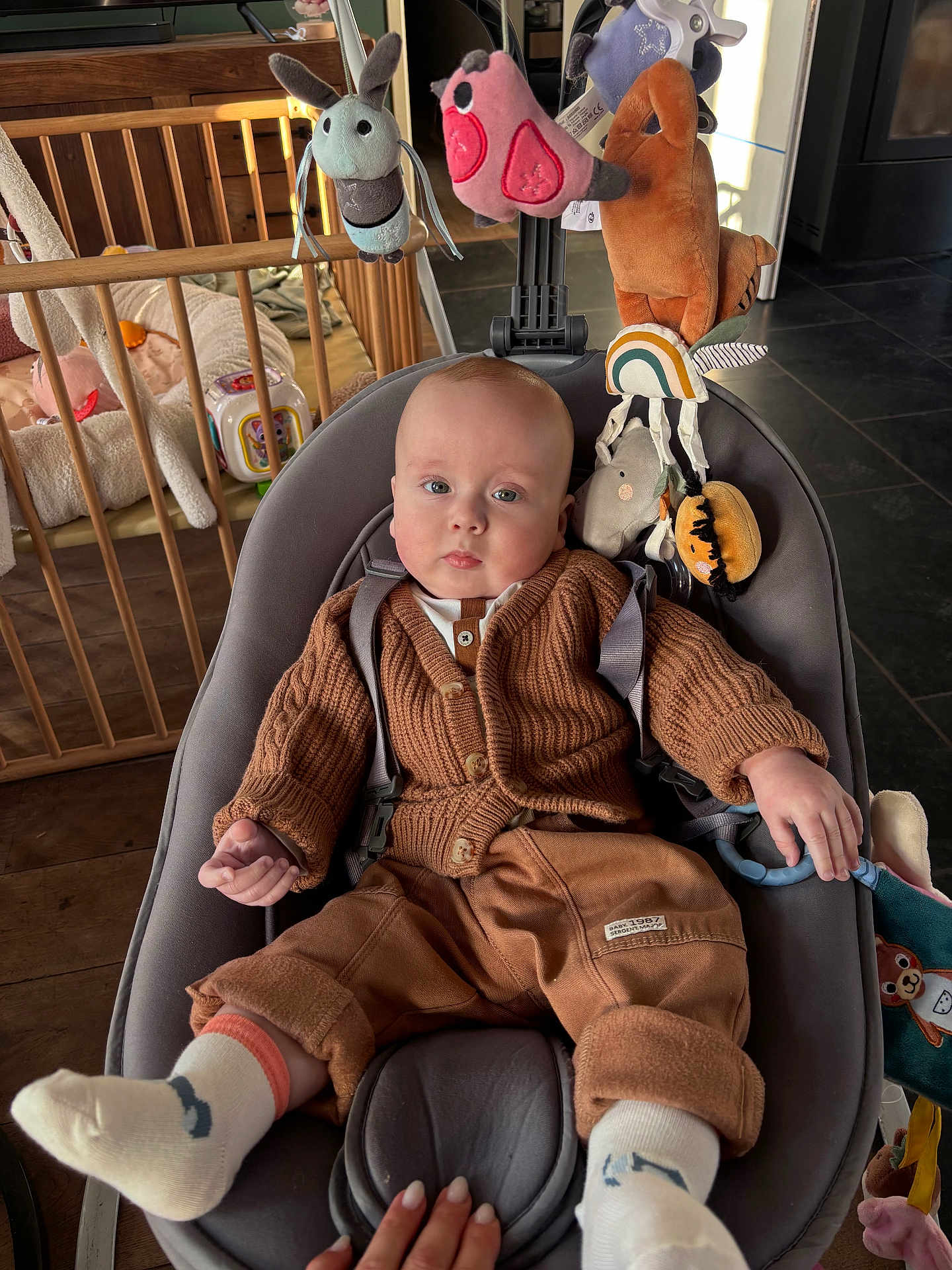 Charles a rejoint le concours — aidez-le/la à gagner de superbes lots ! baby, infant, child, baby_bouncer, carseat, cardigan, plush_toy, mobile_toys, wooden_crib, playroom, socks, hand, floor_tiles, toy_block, neutral_expression, indoor, cozy, parenting, cute, portrait