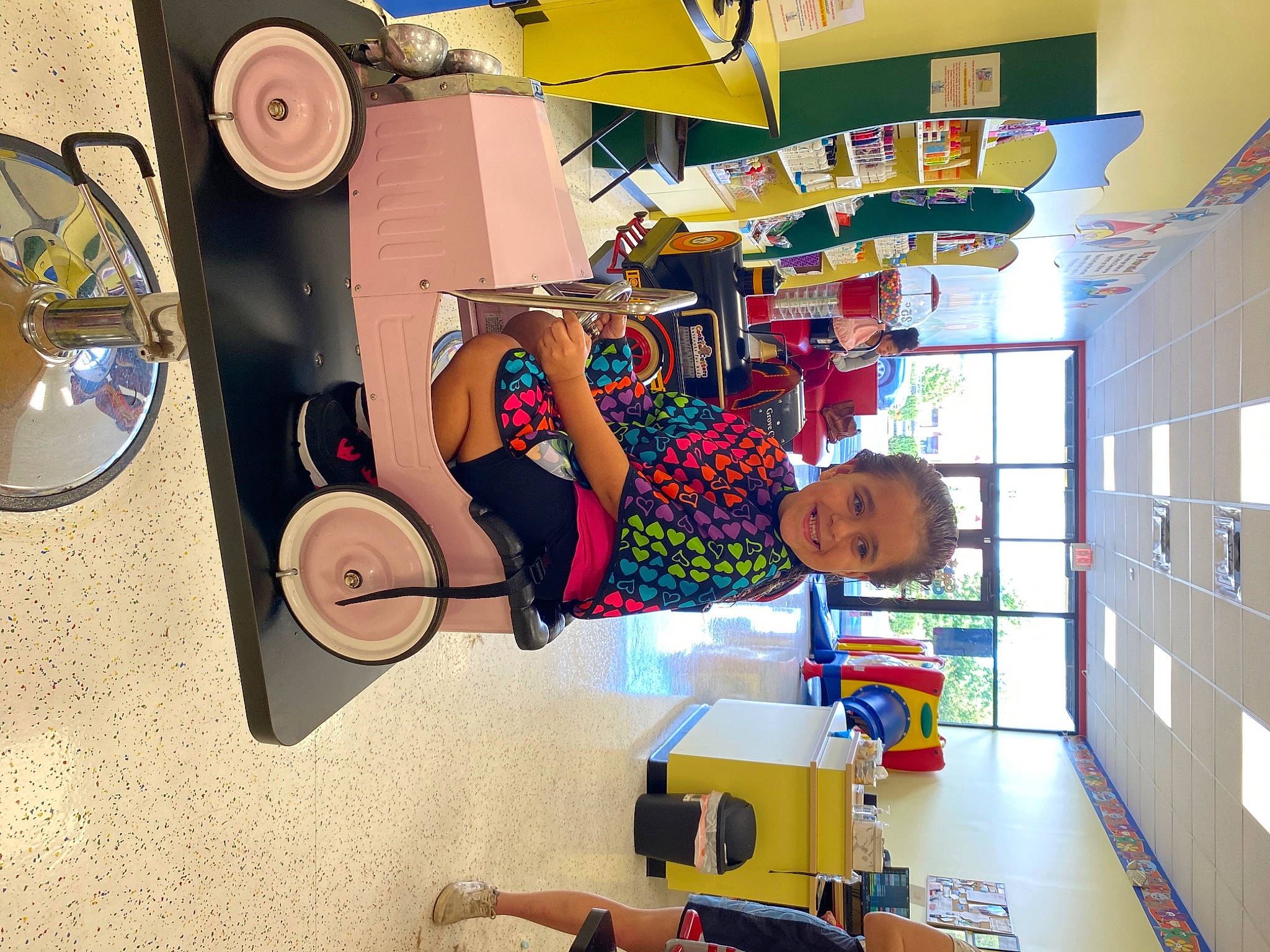 Jazlyn is registered to the contest to win money with this photo: animation, art, bookcase, building, child, circle, fun, illustration, joy, machine, paint, person, plastic, platter, play, room, shelf, shelving, space, tableware