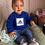 adidas, baby, baby_care, basket, blue_sweatshirt, bunny_pattern, changing_pad, child, clothing, diaper, expression, face, hand, indoor, jeans, nursery, person, shoes, skin, toddler