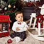 baby, child, christmas, christmas_tree, cute, decorations, festive, floor_rug, holiday, indoor, letters, mailbox, ornament, plaid_pants, red_bow_tie, rocking_horse, toy, tree, white_shirt, winter