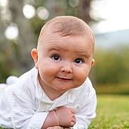 Mathias participe au concours pour gagner de l'argent avec cette photo : baby, child, infant, grass, outdoor, smile, face, cute, white_clothing, portrait, nature, greenery, happy, toddler, young, lying_down, expression, skin, head, eyes