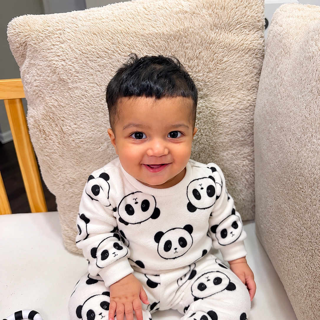 Mohan is registered to the contest to win money with this photo: baby, chair, child, clothing, cushion, face, furniture, hair, happy, home, indoor, infant, pajamas, panda, photography, playroom, portrait, sitting, smiling, toy