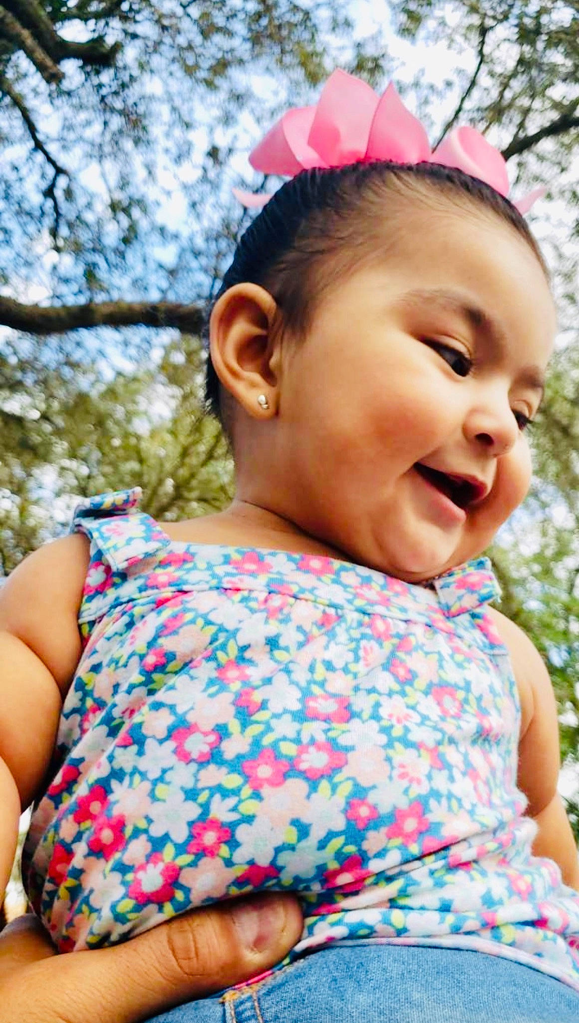 Elsie is registered to the contest to win money with this photo: baby, cheek, child, design, ear, face, fashion_accessory, grass, hair_accessory, happy, head, lip, neck, pattern, person, pink, skin, smile, summer, toddler