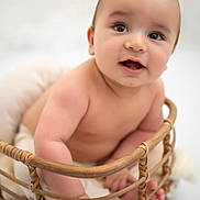 Luca participe au concours pour gagner de l'argent avec cette photo : baby, infant, basket, cute, smiling, bare_shoulders, hands, feet, skin, child, portrait, happy, indoors, soft_light, closeup, newborn, curious, expression, seated, warm
