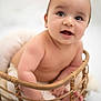 baby, infant, basket, cute, smiling, bare_shoulders, hands, feet, skin, child, portrait, happy, indoors, soft_light, closeup, newborn, curious, expression, seated, warm