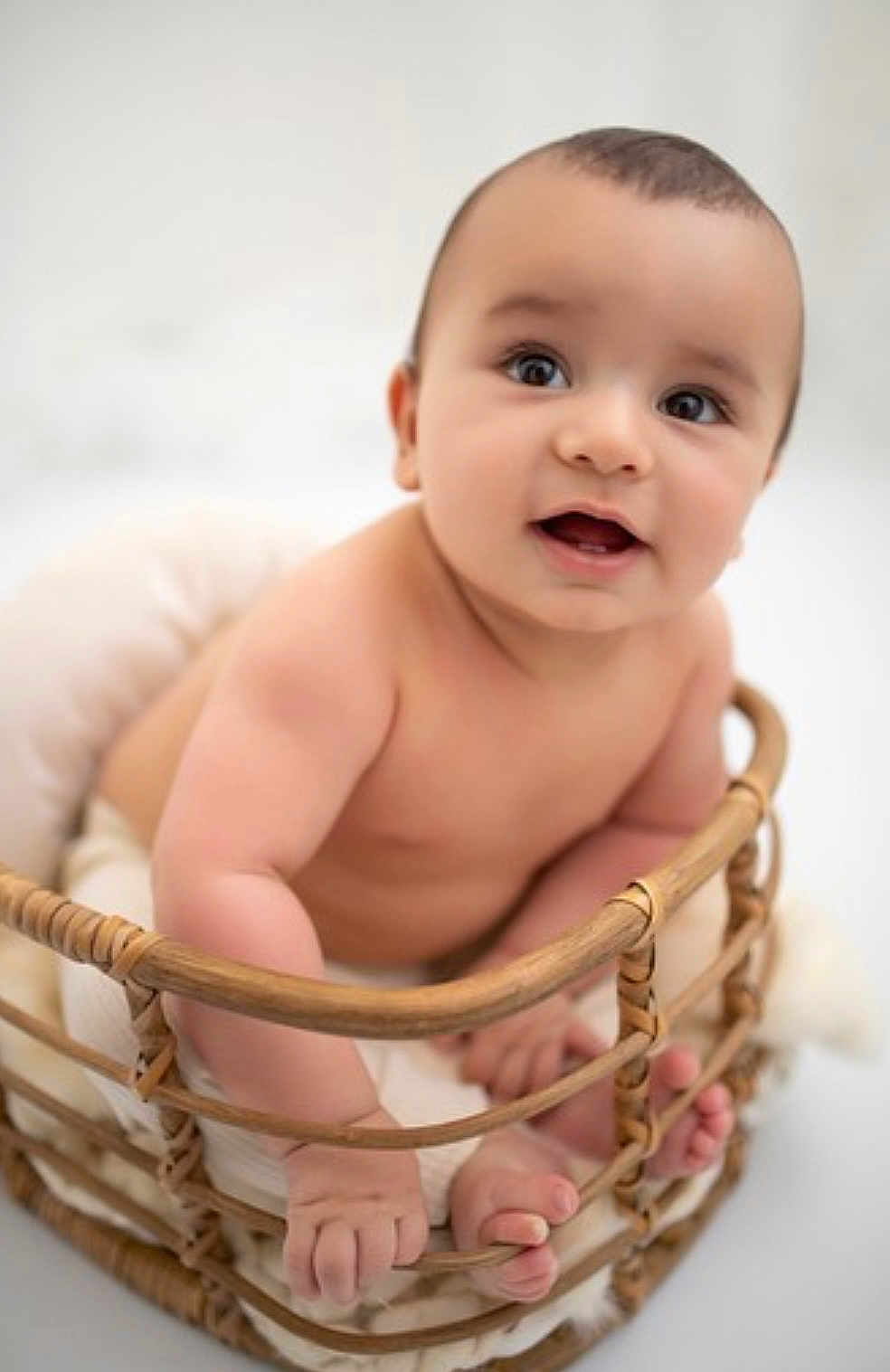 Luca participe au concours pour gagner de l'argent avec cette photo : baby, infant, basket, cute, smiling, bare_shoulders, hands, feet, skin, child, portrait, happy, indoors, soft_light, closeup, newborn, curious, expression, seated, warm